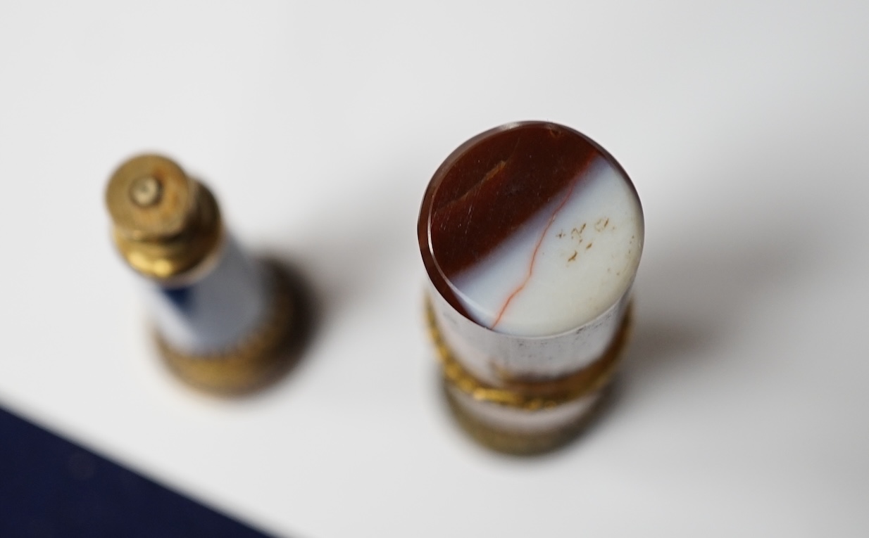 A 19th century agate and gilt metal table seal with gilt snake decoration and a smaller lapis lazuli seal, tallest agate seal 7cm high (2). Condition - fair